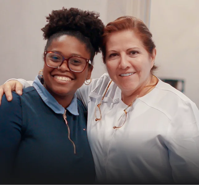 Dental staff member and patient smiling together at a San Diego dental clinic.
