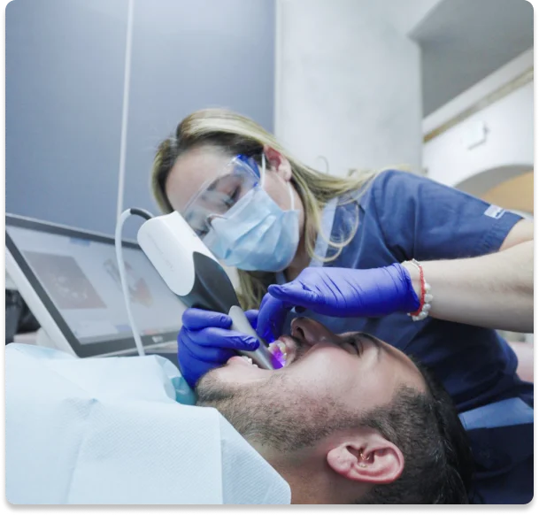 Dentist performing advanced cavity treatment procedure on male patient