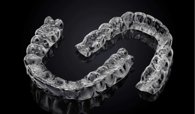 Upper and lower Invisalign clear aligner trays used for invisible orthodontic treatment.