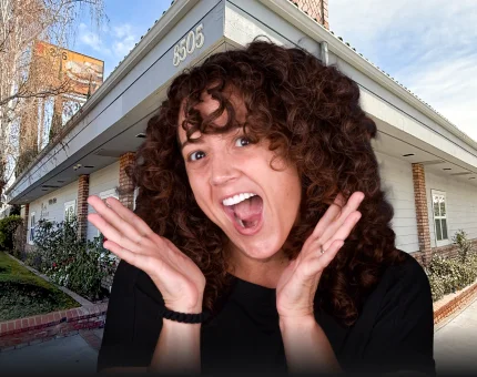 Smiling patient outside the dental clinic after receiving high-value dental care.