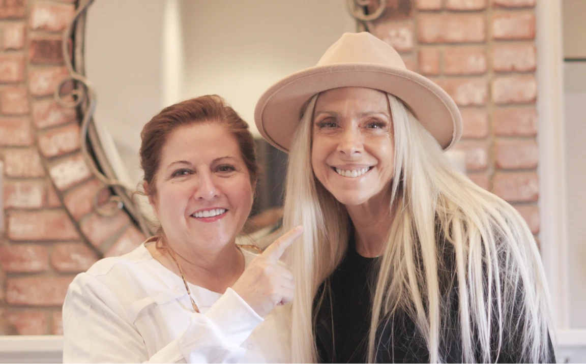 Dental staff member and patient smiling together at a San Diego dental clinic.