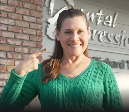 Dental staff member and patient smiling together at a San Diego dental clinic.